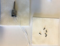 Figure 1: Implant driver ligated with floss and new prosthetic screws Figure 1: Implant driver ligated with floss and new prosthetic screws