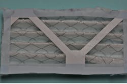 Figure 3a: Cut out air filter to size; the tape protects from sharp wire. Figure 3a: Cut out air filter to size; the tape protects from sharp wire.